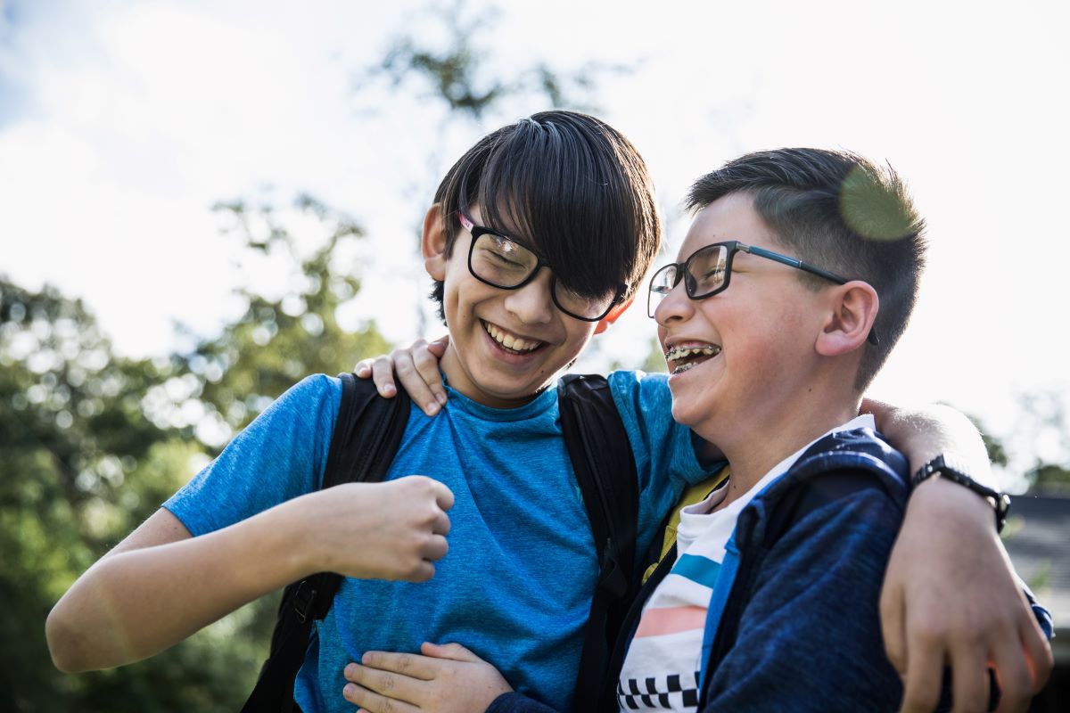 two children wearing glasses laughing